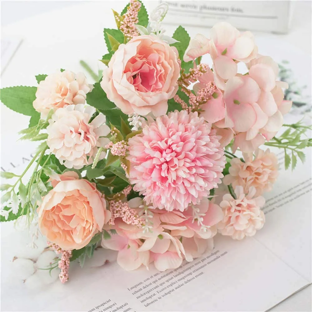 Bouquet of pink and peach flowers on a white surface