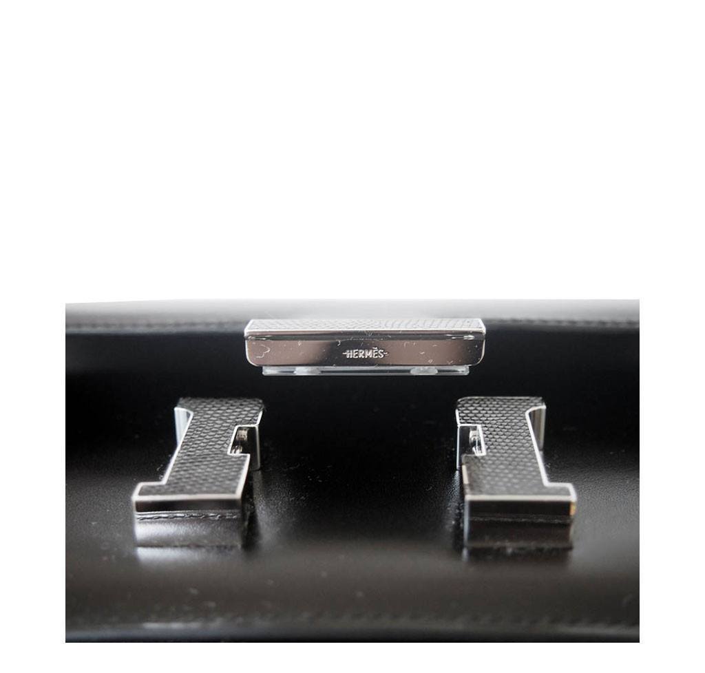 Close-up of a Hermes bag with metal clasp on a white background