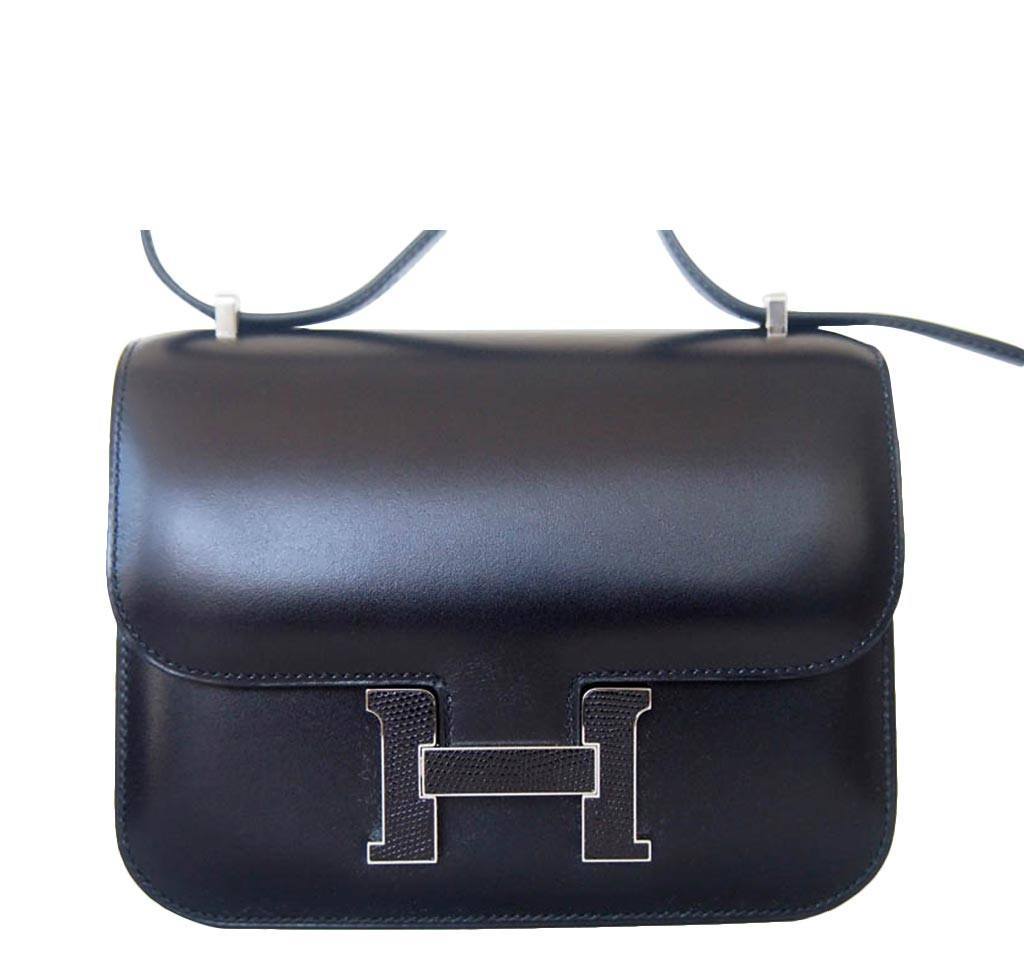 Black handbag with a silver 'H' logo on a white background
