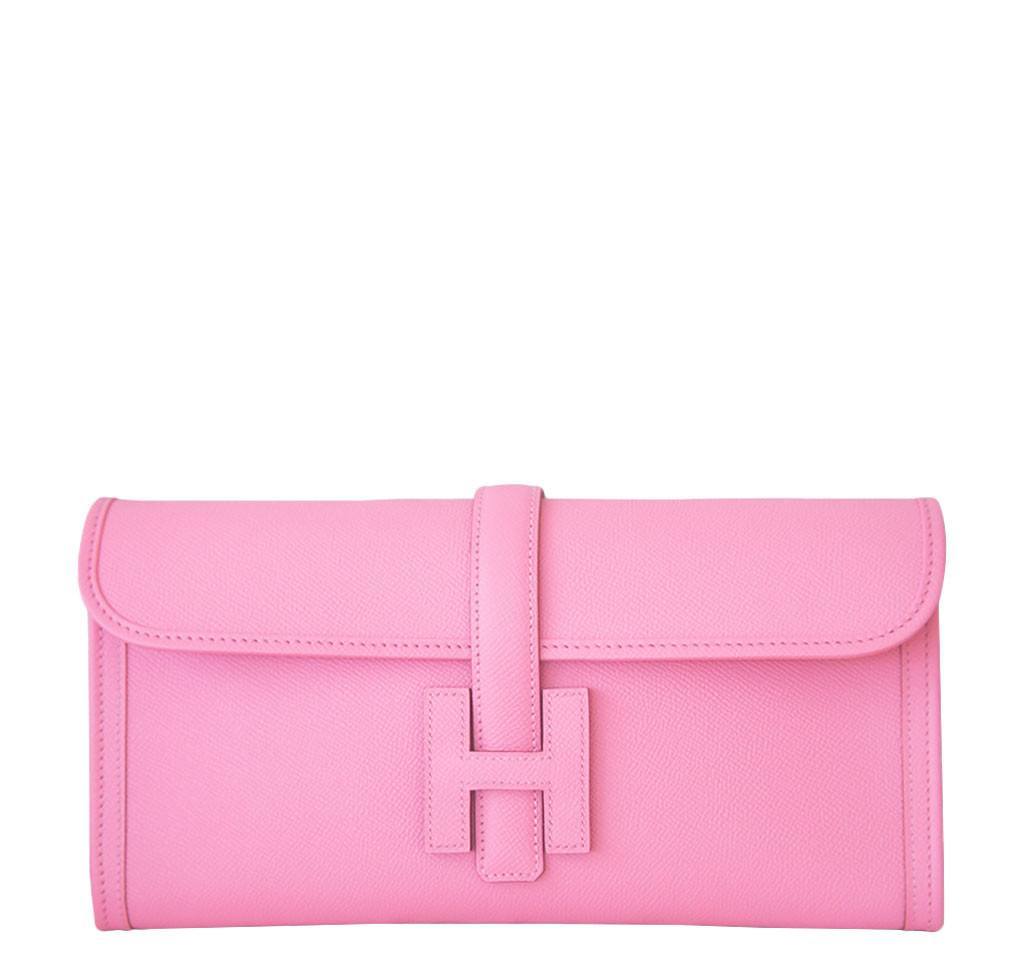 Pink clutch bag with a clasp on a white background