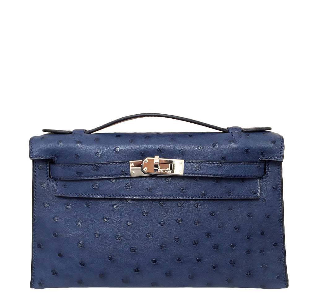 Blue ostrich leather handbag with a silver clasp on a white background