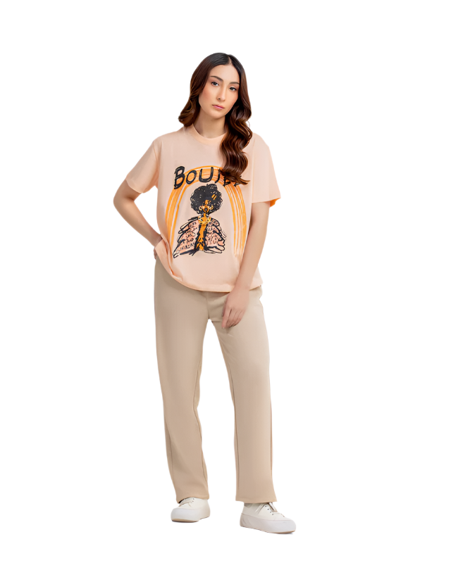 Woman wearing a graphic t-shirt and beige pants on a white background