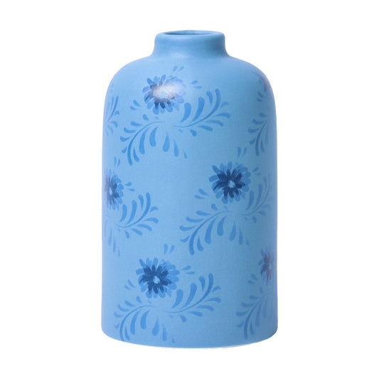 Blue ceramic vase with floral patterns on a white background