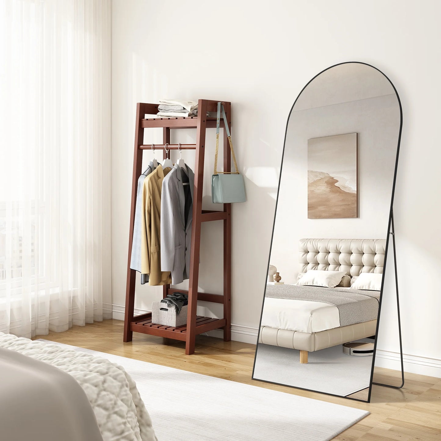 Full-length mirror leaning against a wall in a bedroom with a wooden shelf and bed.