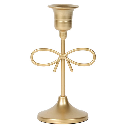 Gold candle holder with bow design on a white background