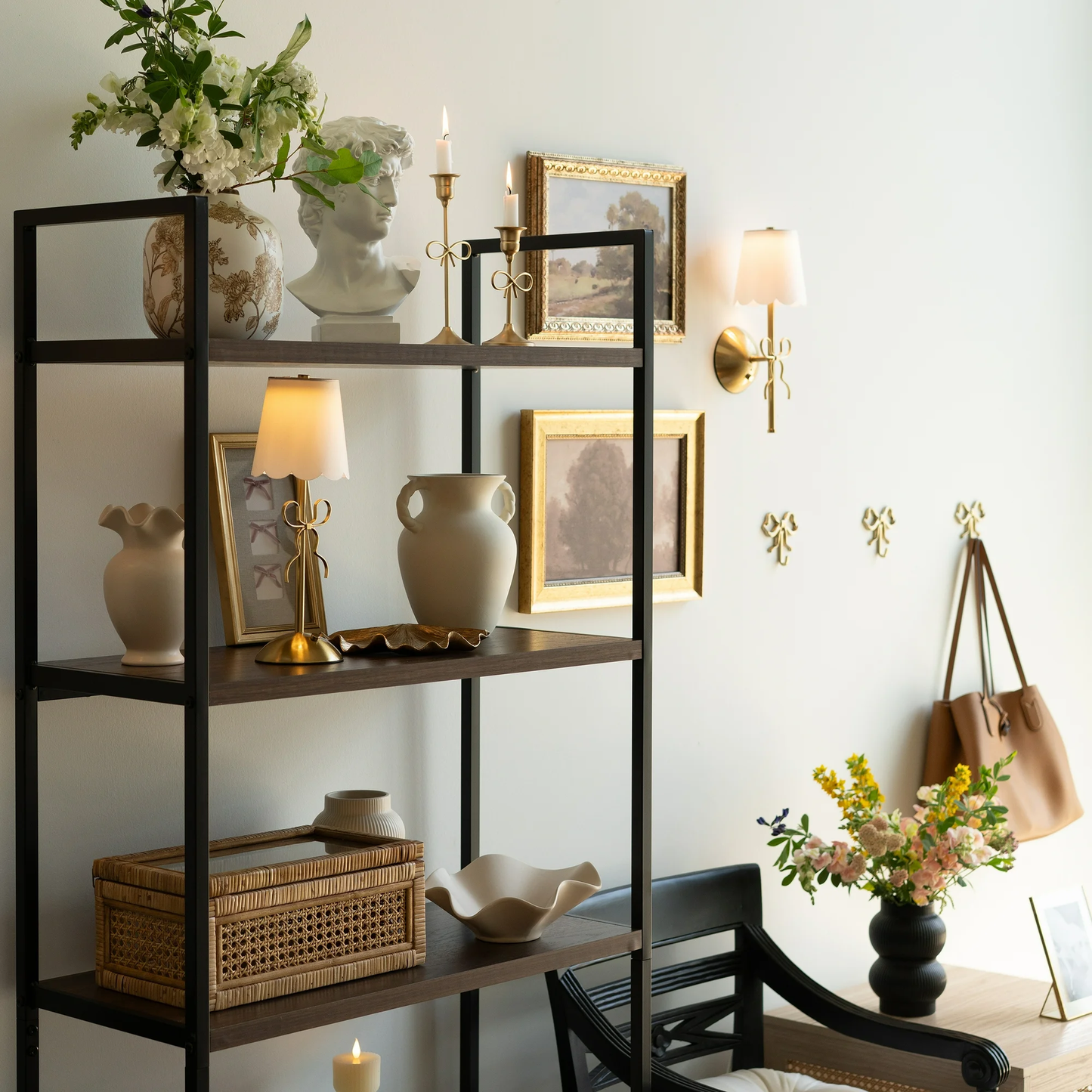 Decorative room interior with shelves, vases, and wall sconces.