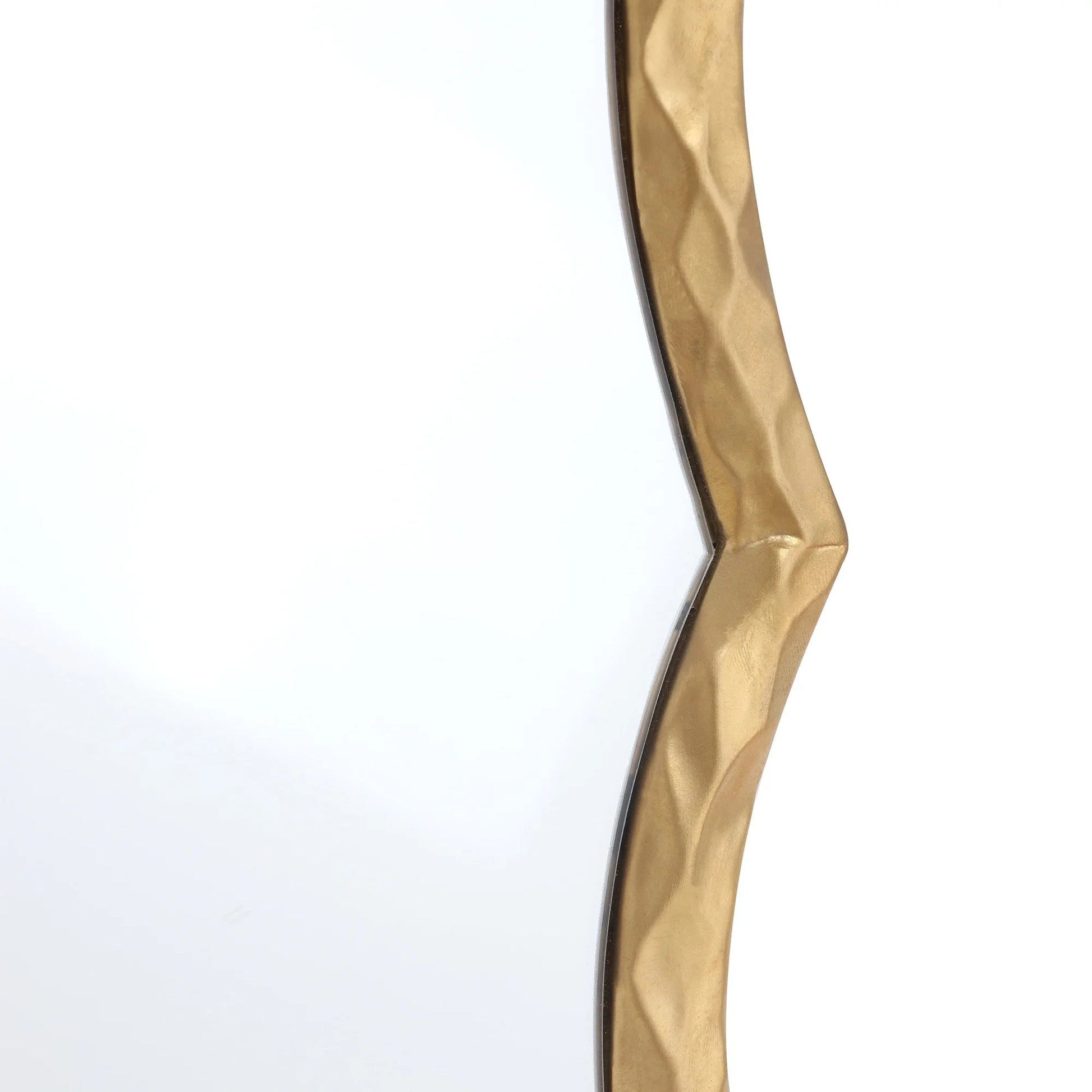 Gold decorative wall piece with wavy design on a white background