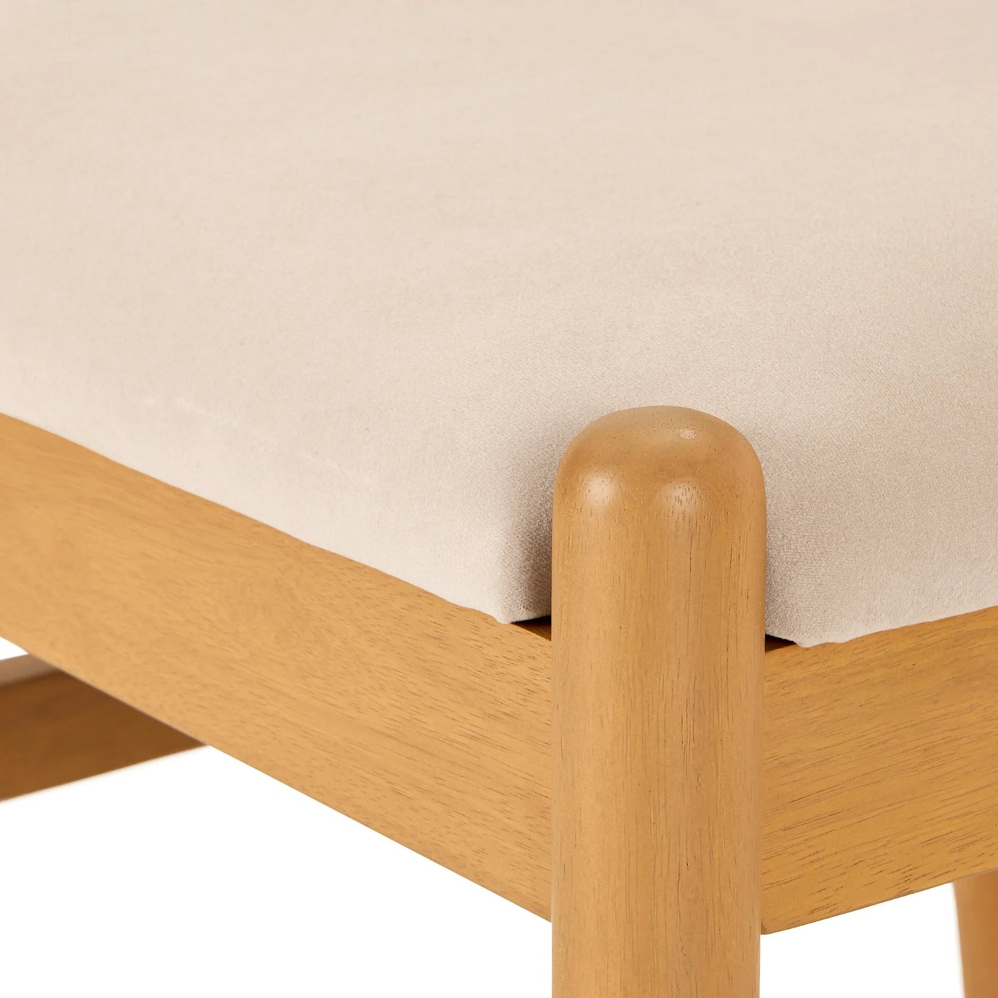 Wooden bed frame corner with beige mattress against a plain background