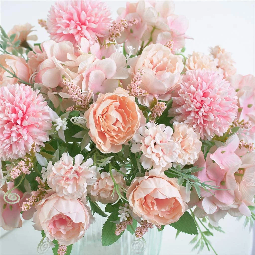 Bouquet of pink and peach flowers with green leaves on a light background