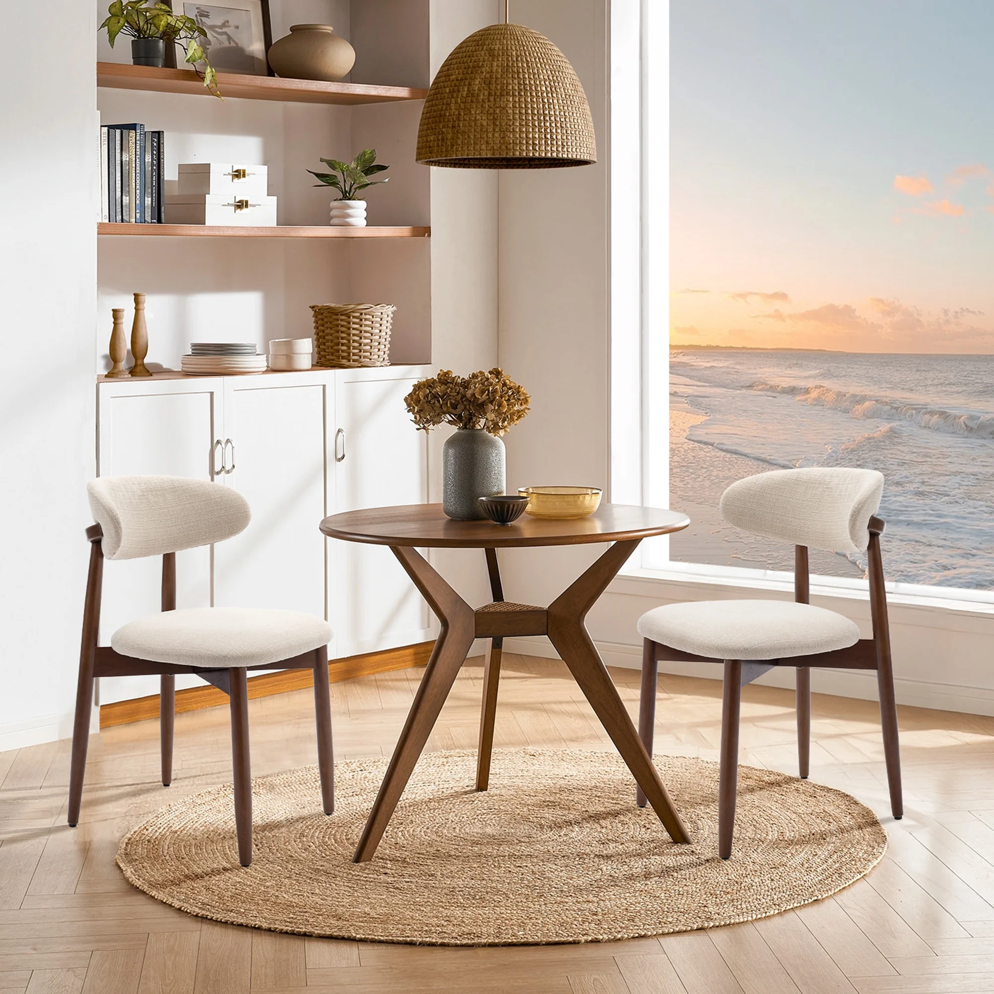 Dining area with wooden table and chairs by a window with a view of the ocean.