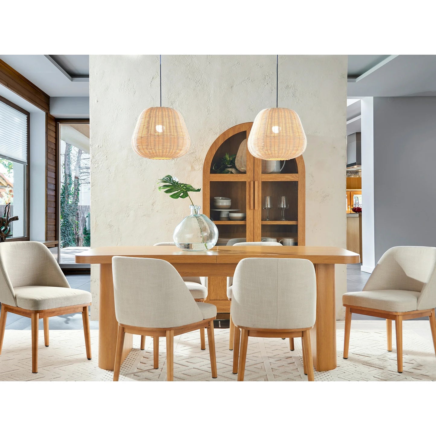 Dining room with wooden table and chairs, pendant lights, and a cabinet.